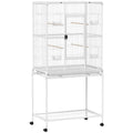 White large bird cage on a wheeled stand with a bottom shelf on a white background