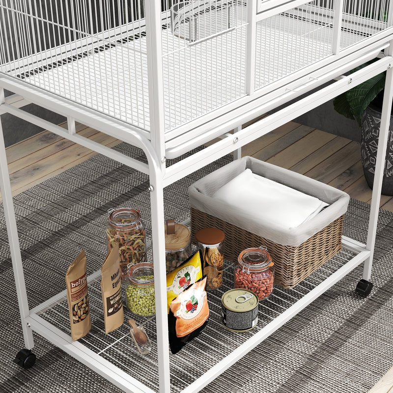 Close-up of the bottom wire shelf holding a basket, jars and bird food