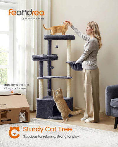 Cat resting inside the cave on the dark grey cat tree
