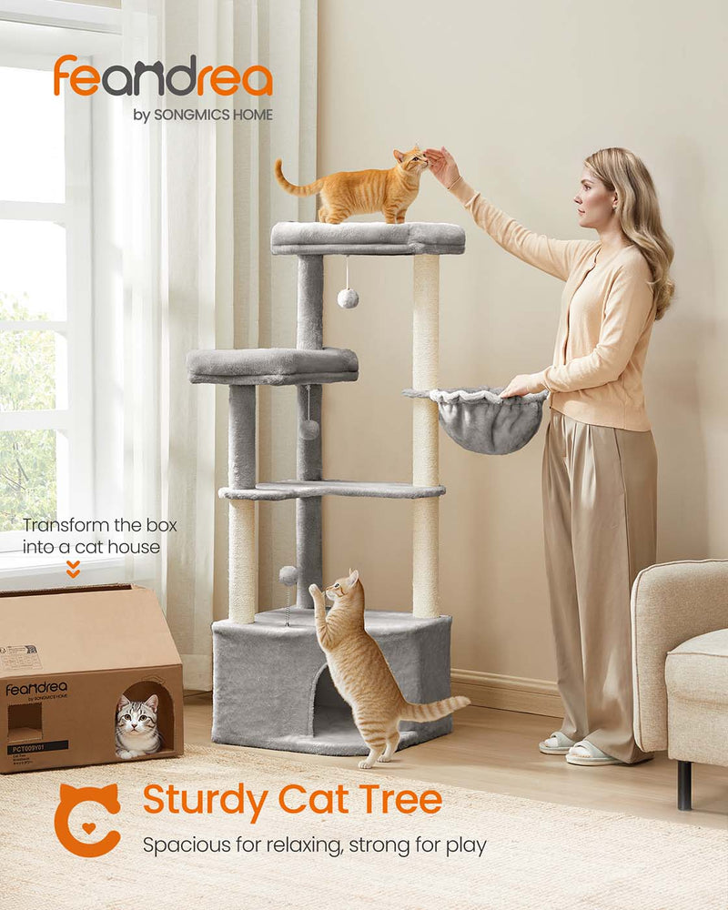 Cat resting inside the cave of the large Feandrea cat tree tower