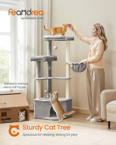 Cat resting inside the cave of the large Feandrea cat tree tower