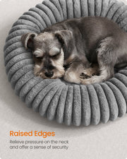 Close-up of a dog leaning against the raised rim edge of the Feandrea dove grey pet bed