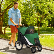 Man walking dog in the large dog stroller in a park