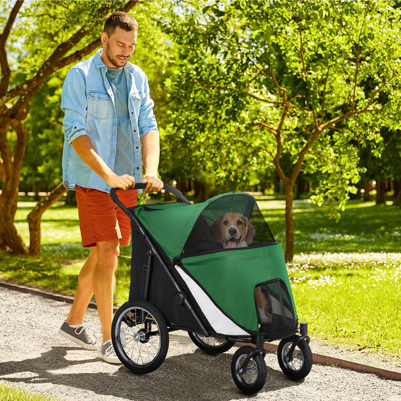 Man walking dog in the large dog stroller in a park