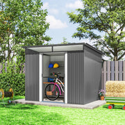 Light grey shed on a lawn with the doors open and a bicycle parked inside