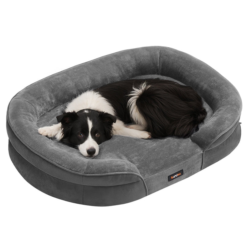 Studio shot of a dog curled up in the Feandrea large orthopaedic dog sofa bed in Slate Grey
