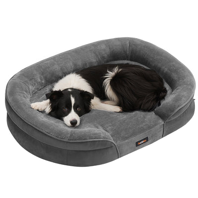 Studio shot of a dog curled up in the Feandrea large orthopaedic dog sofa bed in Slate Grey