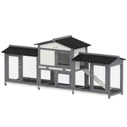 Grey and white rabbit hutch on a plain background with side run boxes and a black asphalt roof