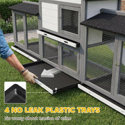 Hand sliding one of the 4 no-leak plastic cleaning trays out from the base of the rabbit hutch