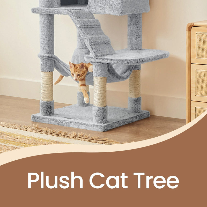Cat resting in the hideaway cave of the large white-grey cat tree tower