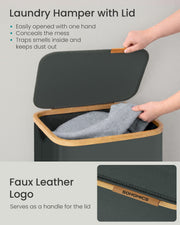 Hand lifting the lid by the faux leather Songmics tab on the bamboo edge
