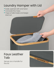 Close-up of hands opening the laundry hamper lid using its faux leather tab handle