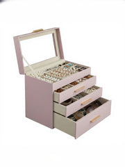 The jewellery box with its glass lid raised and all 3 drawers pulled out and filled with jewellery