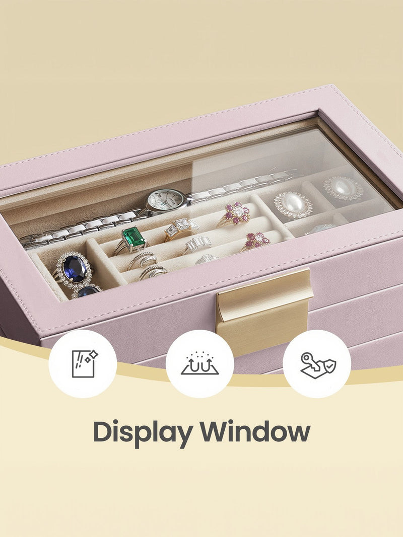 Close-up through the glass lid at the top tray holding a watch, rings and pearl earrings