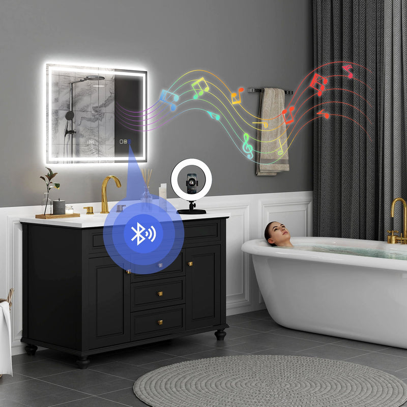 Lifestyle bathroom scene showing the LED mirror streaming music over Bluetooth