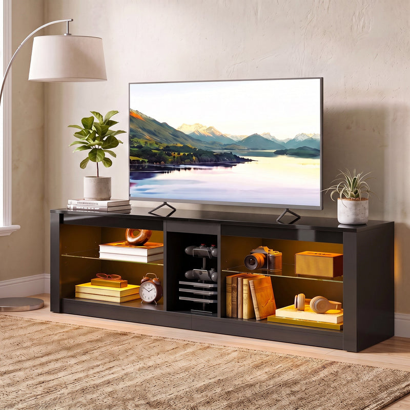 Black TV stand with LED lit shelves and a TV on top beside a floor lamp