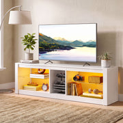 White TV stand at an angle beside a floor lamp with a TV on top and books on the shelves