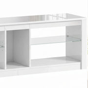 Close-up of the white TV stand's glass shelf and open compartments