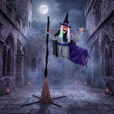 Flying witch decoration displayed in a moonlit castle courtyard