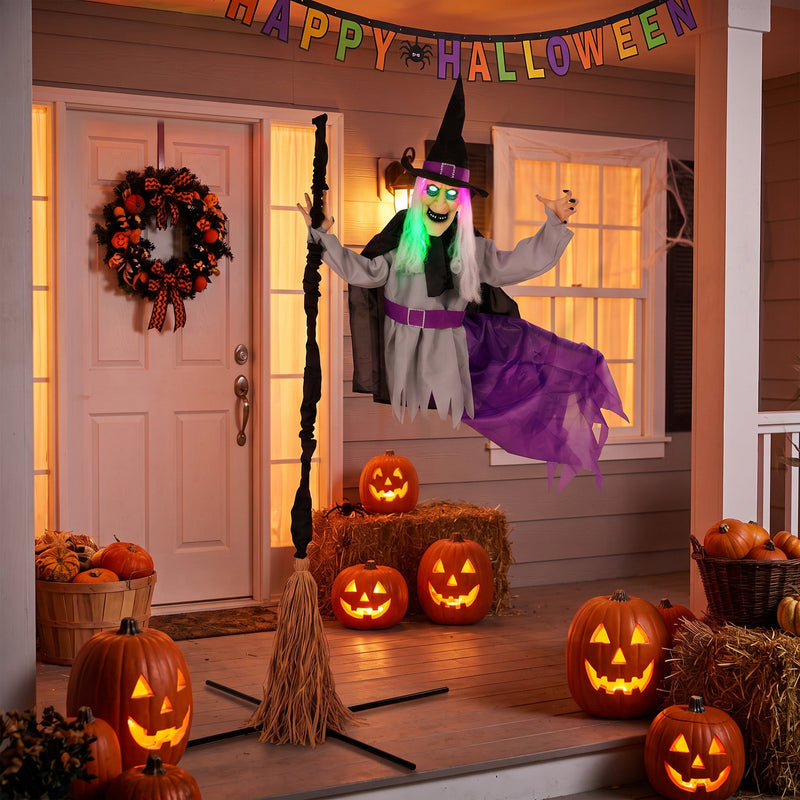 Flying witch decoration set up on a porch decorated for Halloween