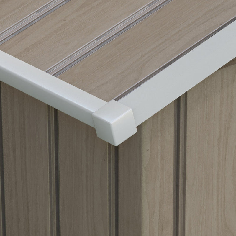 Close-up of the wood-effect roof panel and white corner trim on the light brown metal shed