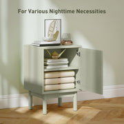 Open cabinet door showing the adjustable shelf holding books and towels