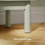 Close-up of a solid wood table leg with non-slip foot pad on a wooden floor