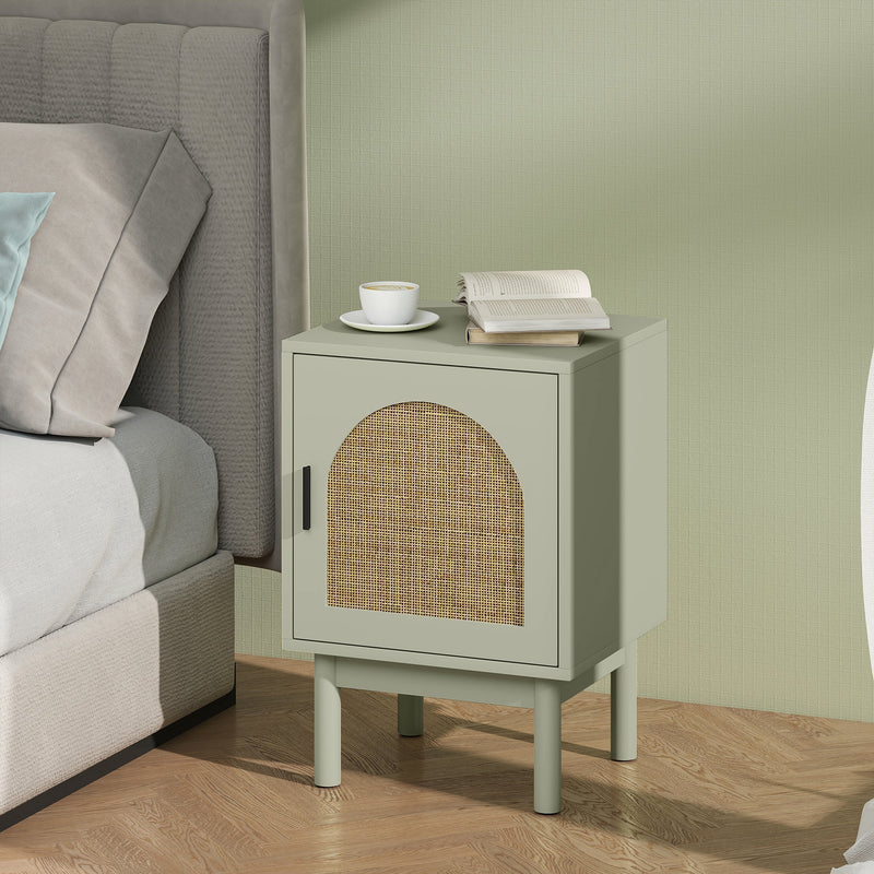 Bedside table styled next to a bed with a coffee cup and open book on top