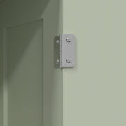 Close-up of the metal hinge on the light green cabinet door