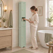 Woman using the light green tall cabinet in a bathroom beside a bath
