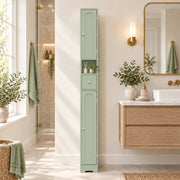 Light green cabinet in a bathroom beside a wall-mounted vanity and a mirror