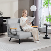 Woman reading in the light grey sofa reclined in the lounge configuration