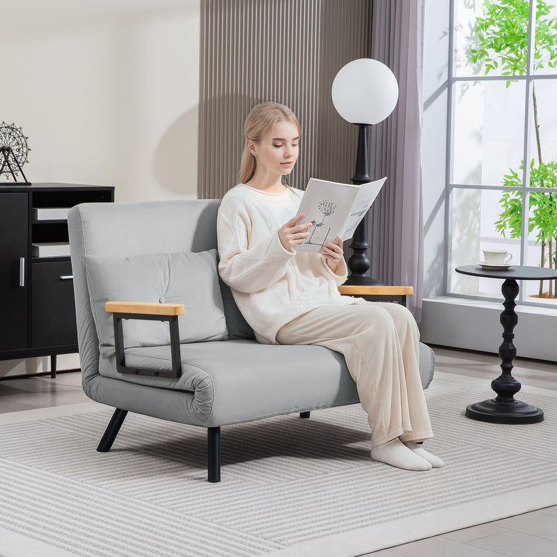 Woman reading in the light grey sofa reclined in the lounge configuration