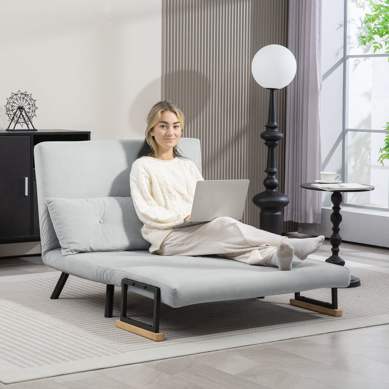 Woman using a laptop in the floor-sofa lounge configuration