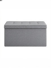 Light grey tufted fabric storage ottoman bench, studio shot