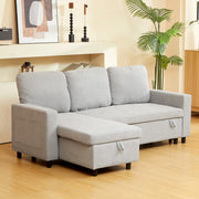 Light grey L-shaped sofa bed styled in a living room with artwork and a palm plant