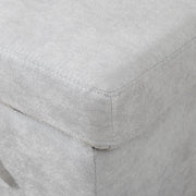 Close-up of the light grey fabric corner seam and cushion edge