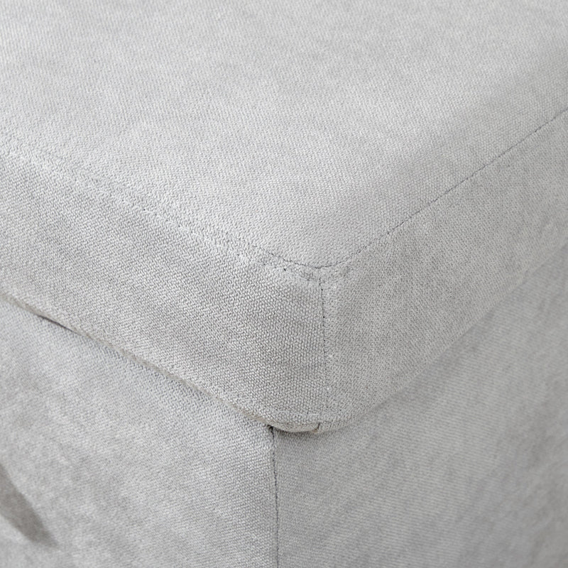 Close-up of the light grey fabric corner seam and cushion edge
