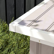 Close-up of the roof edge and white eave trim on the light grey shed