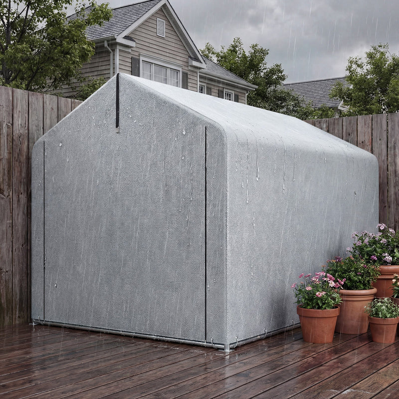 Side view of the closed light grey shed tent against a fence with potted flowers