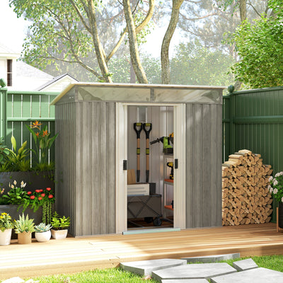 Light grey shed in a garden with sliding doors open showing spades and power tools inside