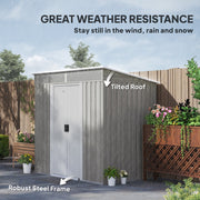 Light grey shed braced against wind and rain, showing the tilted pent roof and steel frame