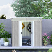Light grey shed against a garden wall with doors open showing a wheelbarrow and hose