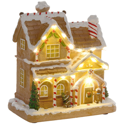 Lit gingerbread house Christmas decoration with snow-covered roof on white background