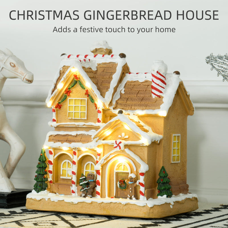 Gingerbread house lit up on a table with a Christmas festive title