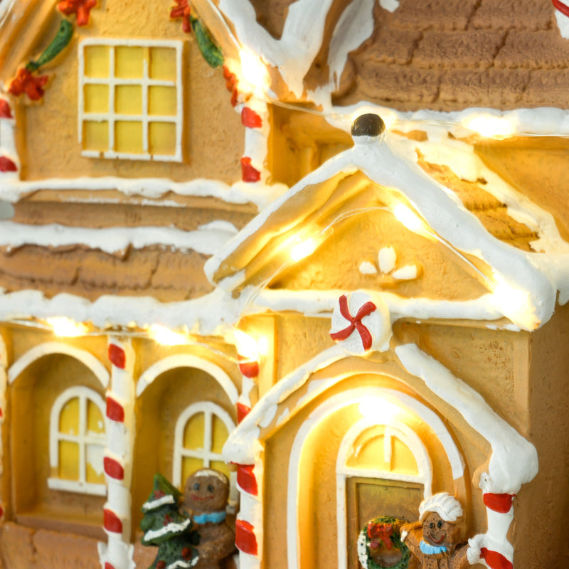 Close-up of the gingerbread house porch with candy cane pillars and gingerbread men