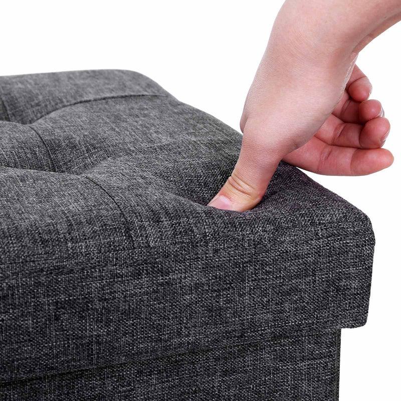 Songmics storage ottoman used as a footstool in a living room setting