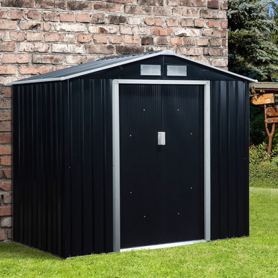 Dark grey 7x4ft metal garden shed with apex roof beside a brick wall