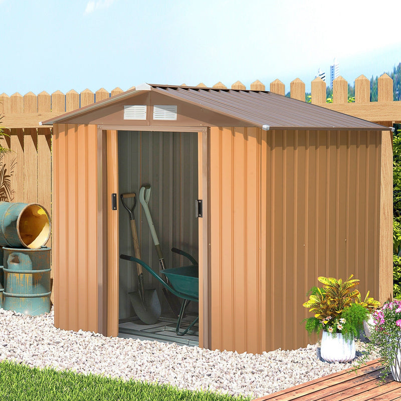 Tan yellow shed by a fence with the door open and tools inside