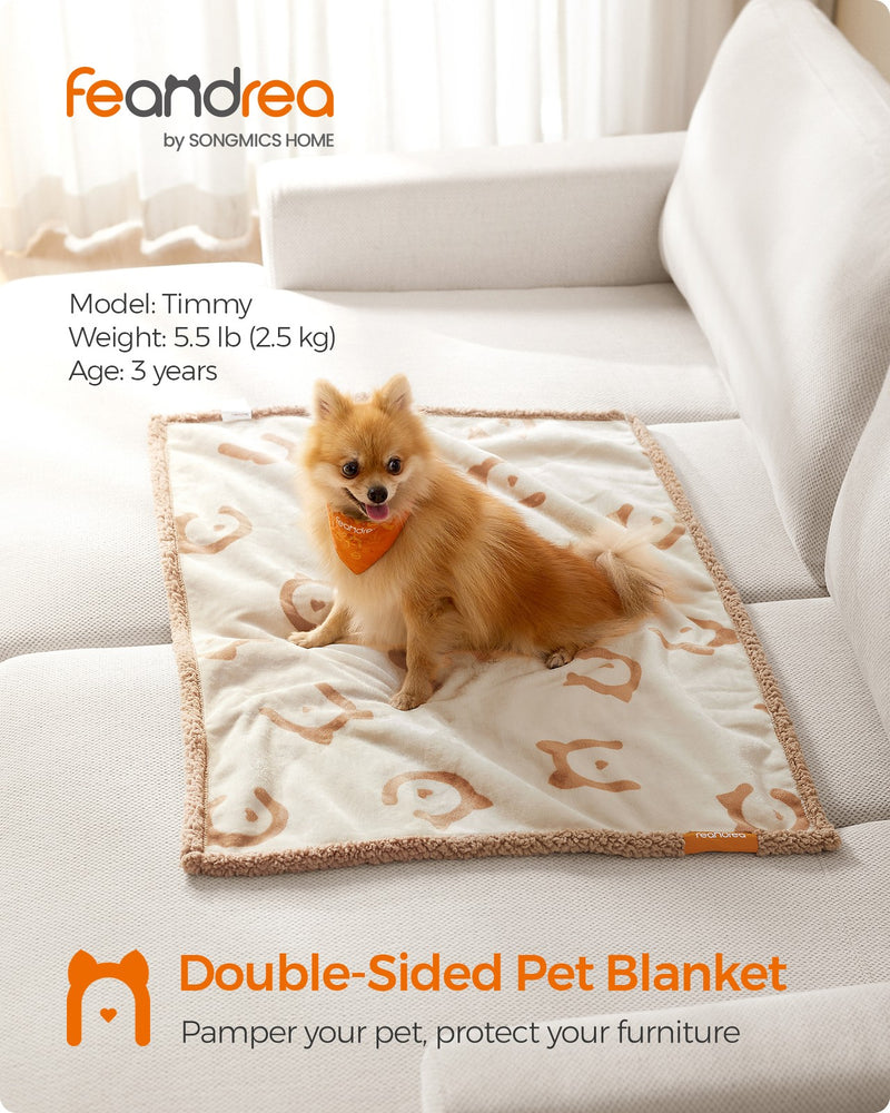 Lifestyle shot of the Feandrea double-sided pet blanket draped on a sofa with a dog